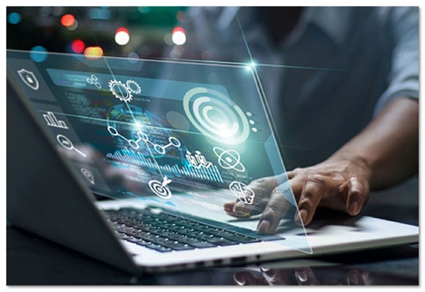 Hands on a laptop keyboard with a glowing screen coming out of the middle of it