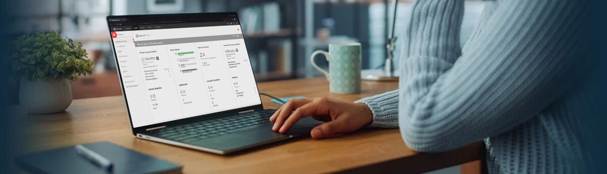 Woman in a soft blue sweater using the WatchGuard Cloud demo on her laptop