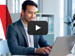 Man in a suit working at a laptop