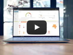 Open laptop sitting on a wooden table showing a WatchGuard Cloud dashboard on the screen